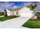 Charming single-story home featuring a three-car garage, well-manicured lawn, and stone accents at 1203 Turtle Island Rd, Lady Lake, FL 32159