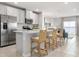 Bright kitchen boasts stainless steel appliances, breakfast bar with seating, and seamless access to living area at 1203 Turtle Island Rd, Lady Lake, FL 32159