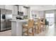Bright kitchen boasts stainless steel appliances, breakfast bar with seating, and seamless access to living area at 1203 Turtle Island Rd, Lady Lake, FL 32159