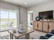 Cozy living room with comfortable seating, stylish decor, and sliding door access to the outdoors at 1203 Turtle Island Rd, Lady Lake, FL 32159
