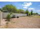Large backyard with a white fence, trees, and sunny sky at 8471 Clearway Dr, Wildwood, FL 34785