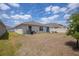 Expansive backyard showing the home's exterior and partial fence at 8471 Clearway Dr, Wildwood, FL 34785