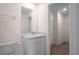 Bathroom with a white vanity, toilet and a glimpse of the walk-in closet at 8471 Clearway Dr, Wildwood, FL 34785