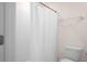 Bathroom showcasing a white shower curtain and toilet at 8471 Clearway Dr, Wildwood, FL 34785