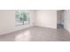 Bright bedroom with neutral walls, tile floors, and a large window allowing natural light at 8471 Clearway Dr, Wildwood, FL 34785