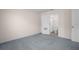 Carpeted bedroom with door to the en-suite bathroom at 8471 Clearway Dr, Wildwood, FL 34785