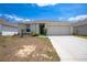 Charming single-story home with a two-car garage, landscaped front yard, and a welcoming entrance at 8471 Clearway Dr, Wildwood, FL 34785