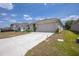 Attractive single-Gathering home with a well-maintained lawn, long driveway, and attached two-car garage at 8471 Clearway Dr, Wildwood, FL 34785