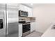 Modern kitchen with stainless steel refrigerator, microwave and range with a decorative backsplash at 8471 Clearway Dr, Wildwood, FL 34785