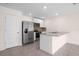 Well-lit kitchen with stainless steel appliances, a breakfast bar and ample counter space at 8471 Clearway Dr, Wildwood, FL 34785