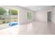 Bright living room features tile flooring, sliding glass doors to the backyard, and neutral paint at 8471 Clearway Dr, Wildwood, FL 34785