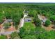 An aerial shot showing a home nestled among trees, featuring a long driveway at 9783 Sw 206Th Court Rd, Dunnellon, FL 34431