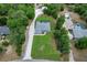 Aerial view of a house with a pool and long driveway amid lush greenery at 9783 Sw 206Th Court Rd, Dunnellon, FL 34431