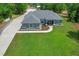Aerial view of home with long driveway, manicured lawn, and welcoming facade at 9783 Sw 206Th Court Rd, Dunnellon, FL 34431