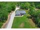 A high angle shot showcasing a gray home with large lawn and extensive driveway at 9783 Sw 206Th Court Rd, Dunnellon, FL 34431