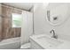 Bathroom featuring white vanity, tub and tile surround at 9783 Sw 206Th Court Rd, Dunnellon, FL 34431