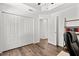 A bright bedroom with wood floors, large closet, and an open doorway to the rest of the home at 9783 Sw 206Th Court Rd, Dunnellon, FL 34431