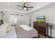 Beautiful bedroom with ceiling fan, tv, wood floors and barn door entrance to bathroom at 9783 Sw 206Th Court Rd, Dunnellon, FL 34431