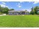 Charming single-story home featuring a well-manicured lawn and a welcoming front porch with decorative columns at 9783 Sw 206Th Court Rd, Dunnellon, FL 34431