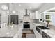 Contemporary kitchen with stainless steel appliances, granite countertops, and modern lighting fixtures at 9783 Sw 206Th Court Rd, Dunnellon, FL 34431