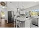 Island kitchen with stainless steel appliances, pendant lighting, and bar stool seating at 9783 Sw 206Th Court Rd, Dunnellon, FL 34431