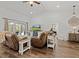 Bright living room featuring hardwood floors, ceiling fan, slider to outdoor living area, and neutral decor at 9783 Sw 206Th Court Rd, Dunnellon, FL 34431