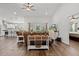 Open living area with a decorative table, hardwood floors, ceiling fan, and large window for natural light at 9783 Sw 206Th Court Rd, Dunnellon, FL 34431
