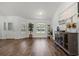 Spacious living room featuring hardwood floors, large windows, and stylish decor, creating an inviting atmosphere at 9783 Sw 206Th Court Rd, Dunnellon, FL 34431