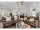 Spacious living room with plush seating, vaulted ceiling, modern decor, and abundant natural light at 9783 Sw 206Th Court Rd, Dunnellon, FL 34431