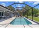 Inviting screened-in pool area with comfortable seating, perfect for relaxation and outdoor entertainment at 9783 Sw 206Th Court Rd, Dunnellon, FL 34431