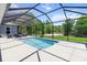 Enclosed pool with clear blue water, surrounded by a spacious deck and a lush green lawn at 9783 Sw 206Th Court Rd, Dunnellon, FL 34431
