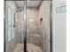 Walk-in shower with seat, niche, rainfall shower head and neutral colored tile at 9783 Sw 206Th Court Rd, Dunnellon, FL 34431