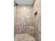 Walk-in shower with seat, niche, rainfall shower head and neutral colored tile at 9783 Sw 206Th Court Rd, Dunnellon, FL 34431