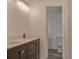 Bright bathroom featuring double sinks, modern vanity and a separate toilet room at 10859 William And Mary Ct, Orlando, FL 32821