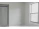 Neutral bedroom with large window, closet, and sleek flooring, offering a bright and airy feel at 10859 William And Mary Ct, Orlando, FL 32821