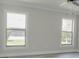 Bedroom with new floors, fresh paint, bright, dual windows, and ceiling fan offering a serene retreat at 10859 William And Mary Ct, Orlando, FL 32821