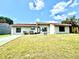 Charming single-story home featuring a red tile roof, well-maintained lawn and a 'For Sale' sign at 10859 William And Mary Ct, Orlando, FL 32821