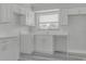 Updated kitchen with white cabinets, sleek countertops, stainless steel fixtures and a bright window view at 10859 William And Mary Ct, Orlando, FL 32821