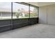 Enclosed screened porch perfect for enjoying the outdoors, features a concrete floor and view of a well-maintained yard at 10859 William And Mary Ct, Orlando, FL 32821