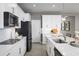 Bright kitchen with stainless steel appliances, white cabinets, and a central island, seamlessly blending style and functionality at 11033 Nellie Crossing Cir, Clermont, FL 34711