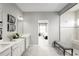 Bathroom with double sinks, a shower, and an entrance to a bedroom at 11037 Nellie Crossing Cir, Clermont, FL 34711