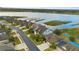 Aerial showcases community waterfront homes with beautiful views of the lake, docks, and picturesque landscaping at 1382 Heritage Landings Dr, Lakeland, FL 33805