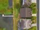 Aerial view showing the house with a dock on the lake and a manicured lawn at 1382 Heritage Landings Dr, Lakeland, FL 33805