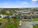 Community aerial featuring waterfront homes with backyard docks, screened lanais, and well-manicured lawns at 1382 Heritage Landings Dr, Lakeland, FL 33805