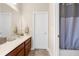 Bright bathroom featuring a double sink vanity and a shower-tub combo with a white door at 1382 Heritage Landings Dr, Lakeland, FL 33805