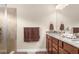 Modern bathroom with a granite countertop, dark wood cabinetry, and modern fixtures at 1382 Heritage Landings Dr, Lakeland, FL 33805