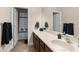 Bathroom featuring a double sink vanity, a shower-tub combo with stylish black accents at 1382 Heritage Landings Dr, Lakeland, FL 33805
