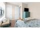 Comfortable bedroom with coordinated bedding, blue dresser, plush carpet, and a sunlit window at 1382 Heritage Landings Dr, Lakeland, FL 33805
