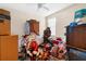 Cluttered bedroom with disorganized items and furniture, needing decluttering and staging at 1382 Heritage Landings Dr, Lakeland, FL 33805