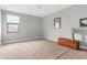 Spacious bedroom with neutral carpet, complemented by a wood chest and natural light from the window at 1382 Heritage Landings Dr, Lakeland, FL 33805
